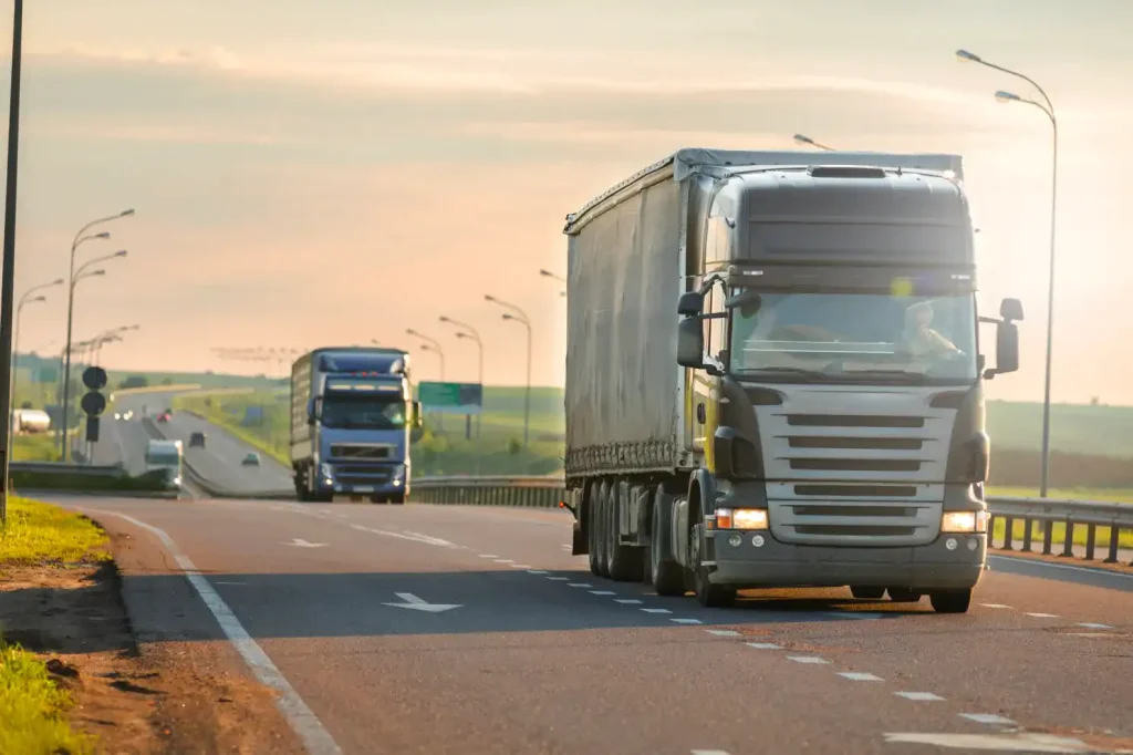 Truck and freight train transporting goods through a scenic landscape, depicting efficient inland logistics.