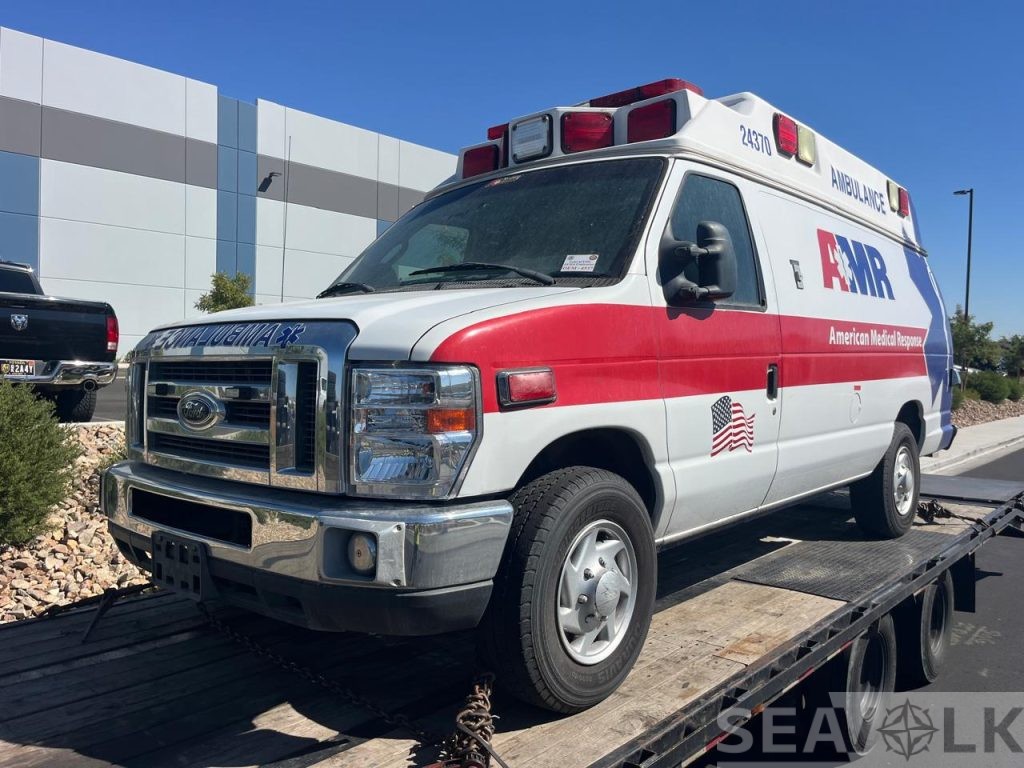 Ford E-350 ambulance on a transport trailer, front-side view — Utah to Pennsylvania
