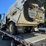 Rear view of the street sweeper secured on a trailer — U.S. pickup for Bolivia