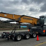 Liebherr LH 80 Material Handler: A large wheeled material handler with its handling boom folded for transport (view 3)